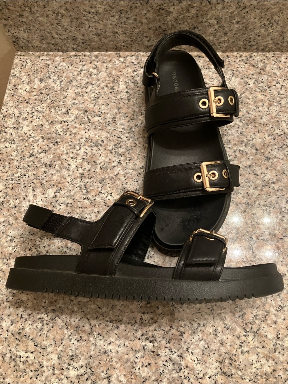 Black sandals with gold buckle detail